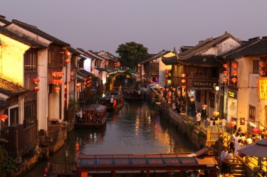 The bustling watertown of Suzhou is at its most beautiful at dusk with the markets and brightly lit lanterns came to live.