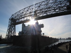 Edwin H. Gott under the Aerial Lift Bridge. The canal that runs under the bridge has quite a story of its own. Construction began in 1870, but became a contentious issue with the neighboring port of Superior, Wisconsin. The city of Superior even went to federal court to halt the construction.