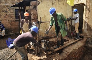 Residents excavate at the site of a recently-discovered mass grave in Gasabo district, near the capital Kigali, in Rwanda Thursday, April 26, 2018.