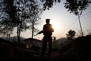 In this March 20, 2018 photo, a Kachin Independence army rebel stands at frontline outpost facing no man's land in Lawa Yang, outside of Laiza, the armed group's headquarters in northern Kachin state, Myanmar.