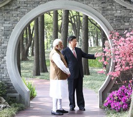 In this photo released by China's Xinhua News Agency, Indian Prime Minister Narendra Modi, left, and Chinese President Xi Jinping talk at a garden in Wuhan in central China's Hubei Province, Saturday, April 28, 2018.