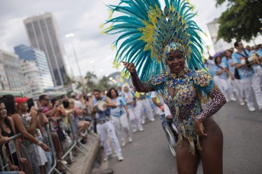 Members of a samba school parade along Copacabana Beach in Rio de Janeiro, Brazil. Musicians and members from Rio de ...