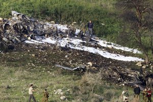 Israeli security stands around the wreckage of an F-16 that crashed in northern Israel, near kibbutz of Harduf, Saturday, Feb. 10, 2018.