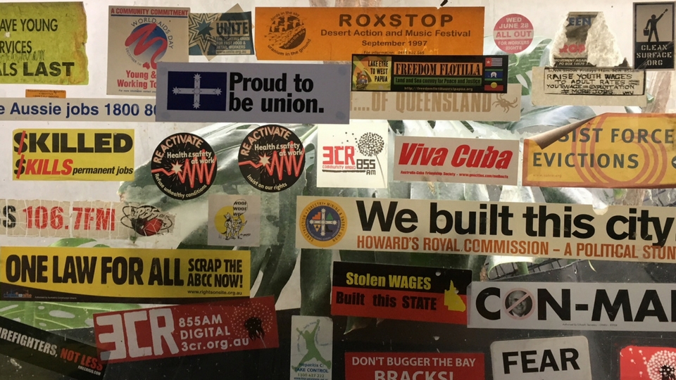 3CR kitchen window of campaign stickers about all things work and solidarity.