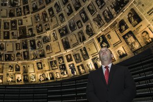 Bulgarian President Rumen Radev looks at pictures of Jews killed during the Holocaust, in the Hall of Names at Yad Vashem Holocaust Museum in Jerusalem, Wednesday, March 21, 2018.