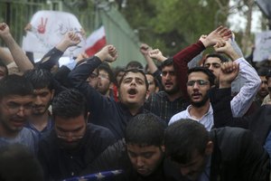 Iranian demonstrators chant slogans during a protest in front of the former U.S. Embassy in response to President Donald Trump's decision Tuesday to pull out of the nuclear deal and renew sanctions, in Tehran, Iran, Wednesday, May 9, 2018.