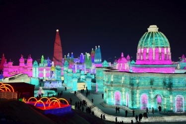 Visitors walk among the attractions at the Harbin International Ice and Snow Festival in Harbin in northeastern China's ...