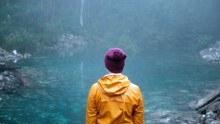 Woman stands at Mount Wellington tarn