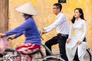 Locals on bicycles in the historic centre of Hoi An, Vietnam.