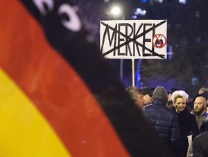 FILE - In this Feb. 24, 2016 file photo people wave German flags in Erfurt, central Germany, during a demonstration initiated by the Alternative for Germany (AfD) party.