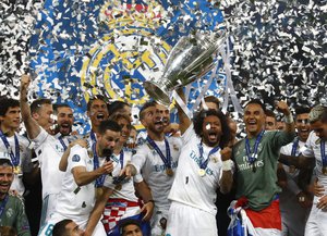 Real Madrid players celebrate with the trophy after winning the Champions League Final soccer match between Real Madrid and Liverpool at the Olimpiyskiy Stadium in Kiev, Ukraine, Saturday, May 26, 2018.