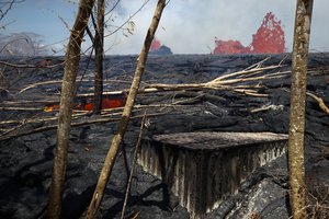 A property is devastated by lava as fissures continue to spew lava in the Leilani Estates subdivision near Pahoa, Hawaii, Tuesday, May 22, 2018.