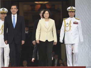 Flanked by outgoing President Ma Ying-jeou, left, Taiwan's new president Tsai Ing-wen, center, arrives for the presidential inauguration ceremony at the Presidential Office, Friday, May 20, 2016, in Taipei, Taiwan.