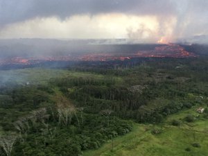 In this aerial photo provided by the U.S. Geological Survey, lava flows from fissure 8 near Pahoa, Hawaii on Wednesday, May 30, 2018.