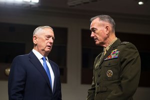 Defense Secretary Jim Mattis speaks with Marine Corps Gen. Joe Dunford, chairman of the Joint Chiefs of Staff, before a Senate Armed Services Committee hearing in Washington, D.C., Oct. 3, 2017