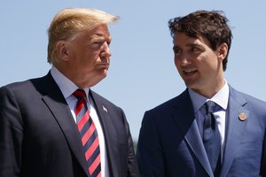 President Donald Trump talks with Canadian Prime Minister Justin Trudeau during a G7 Summit welcome ceremony, Friday, June 8, 2018, in Charlevoix, Canada.