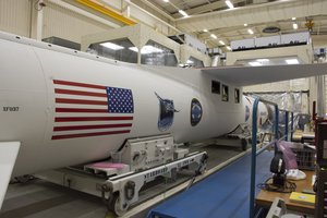 At Vandenberg Air Force Base in California, an Orbital ATK Pegasus XL rocket is seen during payload fairing installation in Building 1555. On board Pegasus are eight NASA Cyclone Global Navigation Satellite System, or CYGNSS, spacecraft