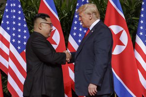 U.S. President Donald Trump shakes hands with North Korea leader Kim Jong Un at the Capella resort on Sentosa Island Tuesday, June 12, 2018 in Singapore.