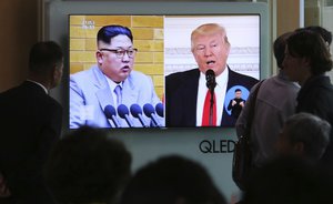 People watch a TV screen showing file footage of U.S. President Donald Trump, right, and North Korean leader Kim Jong Un during a news program at the Seoul Railway Station in Seoul, South Korea, Saturday, April 21, 2018.