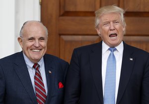 President-elect Donald Trump calls out to media as he and former New York Mayor Rudy Giuliani pose for photographs as Giuliani arrives at the Trump National Golf Club Bedminster clubhouse, Sunday, Nov. 20, 2016, in Bedminster, N.J.