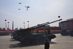 Mobile artillery and helicopters pass by during a mass military parade on Kim Il Sung Square in Pyongyang to mark the 60th anniversary of the Korean War armistice on July 27, 2013. (AP Photo/David Guttenfelder)