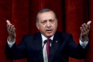 Turkey President Recep Tayyip Erdogan delivers a speech commenting on those killed and wounded during a failed July 15 military coup, in Ankara, Turkey, late Friday, July 29, 2016.