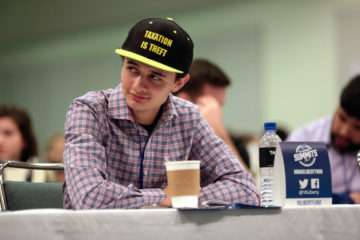 Young Americans for Liberty supporter wearing "Taxation Is Theft" hat. Photo by Gage Skidmore on Flickr.