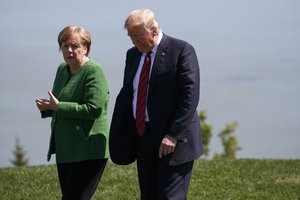 President Donald Trump, right, talks with German Chancellor Angela Merkel after the