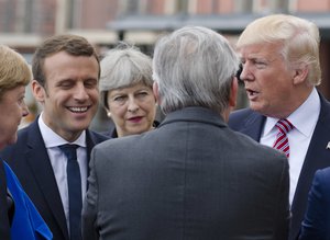 From left, German Chancellor Angela Merkel, French newly elected President Emmanuel Macron, British PM Theresa May, president of the EU Commission Jean-Claude Juncker, back to camera, and US President Donal Trump talk to each other prior to the start of the leaders of the G7 countries summit in the Sicilian citadel of Taormina, Italy, Friday, May 26, 2017.