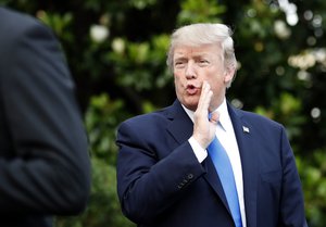 President Donald Trump answers a question as he walks to Marine One to depart the White House, Wednesday, July 12, 2017, in Washington. Trump is headed to Paris for Bastille Day.