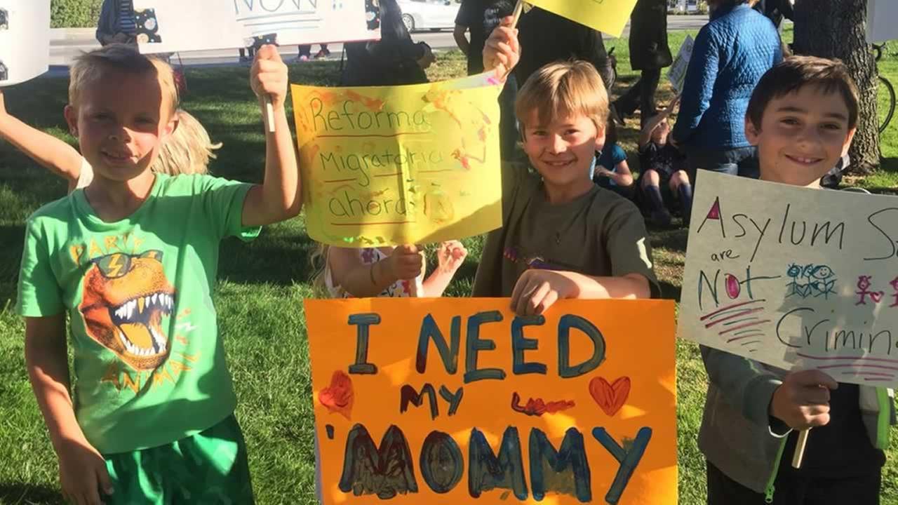 Children hold signs during a vigil opposing the Trump Administrations immigration policies in San Rafael, Calif. on Wednesday, June 20, 2018.