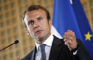 France's new Economy Minister Emmanuel Macron clenches his fist as he delivers a speech during a transition of power ceremony at the Economy Ministry in Paris, Wednesday, Aug.27, 2014.