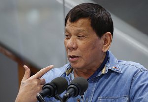 Philippine President Rodrigo Duterte gestures while addressing Filipino Overseas Workers who were repatriated from Kuwait, Tuesday, Feb. 13, 2018 at the Ninoy Aquino International Airport in suburban Pasay city southeast of Manila, Philippines.