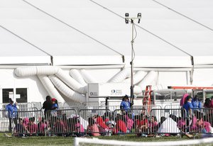 Young children immigrants are shown outside a former Job Corps site that now houses them, Monday, June 18, 2018, in Homestead, Fla. it is not know if the children crossed the border as unaccompanied minors or were separated from family members.