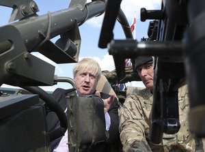 Britain's Foreign Secretary Boris Johnson talks to British armed forces servicemen based in Orzysz, in northeastern Poland, during a ceremony at the Tomb of the Unknown Soldier and following talks on security with his Polish counterpart Jacek Czaputowicz in Warsaw, Poland, Thursday, June 21, 2018.