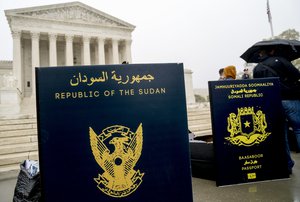 Poster sized enlargements of passports are on display during an anti-Muslim ban rally as the Supreme Court hears arguments about wether President Donald Trump's ban on travelers from several mostly Muslim countries violates immigration law or the Constitution, Wednesday, April 25, 2018, in Washington.