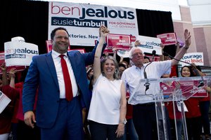 Democrat Ben Jealous, left, rises the hand of his running mate Susie Turnbull and Sen. Bernie Sanders, I-Vt., waves, during a gubernatorial campaign rally in Maryland's Democratic primary at downtown Silver Spring, Md., Monday, June 18, 2018.