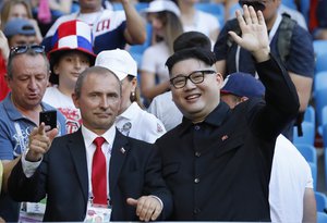 Russia's President Vladimir Putin and a North Korean leader Kim Jong Un lookalike perform during the group A match between Uruguay and Russia at the 2018 soccer World Cup at the Samara Arena in Samara, Russia, Monday, June 25, 2018.