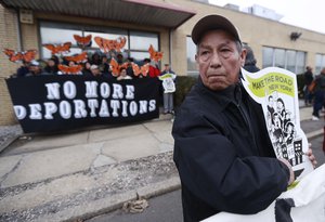 A man holds a sign prior to the start of an immigration protest outside of a detention center, Thursday, Feb. 23, 2017, in Elizabeth, N.J.