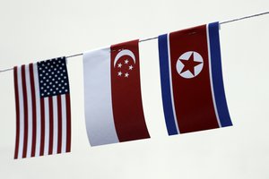 The American, Singaporean and North Korean flags decorate the entrance of a local bar on Thursday, June 7, 2018, in Singapore. U.S.