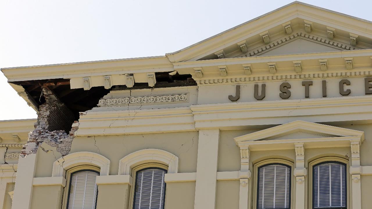 In this file photo from Aug. 24, 2014, an upper corner of the Napa County Courthouse displays structural damage after an earthquake in Napa, Calif.