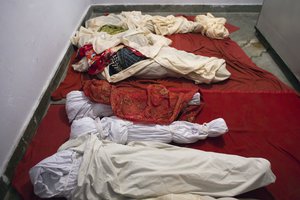 A school uniform shoe is visible under a white sheet in a mortuary where bodies of 23 school children were kept after a school bus fell into a deep gorge about 60km (37 miles) south of Dharmsala, India, Monday, April 9, 2018.