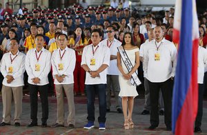 In this photo taken Monday, July 18, 2016, Tanauan City Mayor Antonio Halili, center, leads the flag-raising rites at the city's gymnasium at Tanauan city, Batangas province south of Manila, Philippines. On Monday, July 2, 2018, Philippine police say Mayor Halili, who became controversial for parading drug suspects in public but had been linked to illegal drugs himself, has been shot and killed by a still unknown attacker during a flag-raising ceremony in front of horrified employees. (AP Photo/Bullit Marquez)