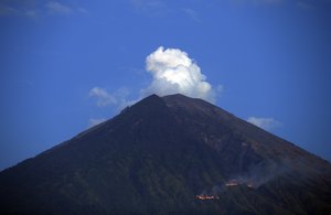 Mount Agung spews smoke in Karangasem, Bali, Indonesia, Tuesday, July 3, 2018.