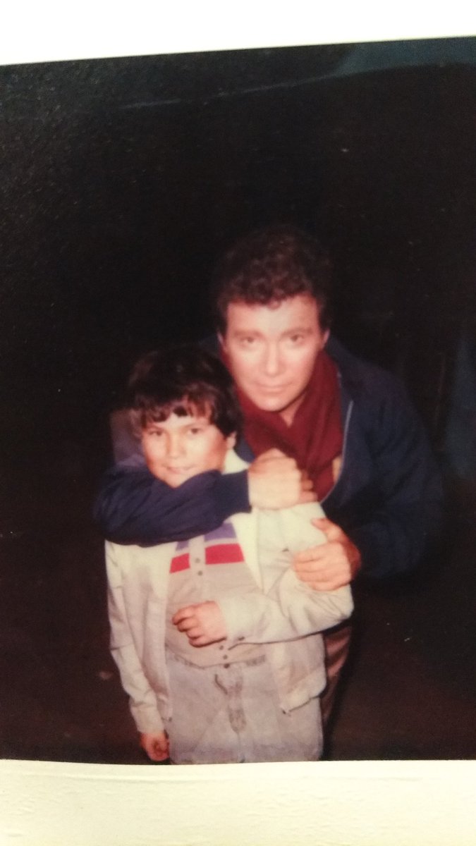 A photo of a young Jesse Wente with William Shatner hugging him in a playful headlock on a TV show set.