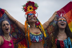 People attend the Gay Pride Parade at Copacabana beach in Rio de Janeiro, Brazil, Sunday, Nov. 19, 2017.