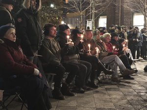 In this Feb. 13, 2018 photo, people hold a candlelight vigil to remember the victims of alleged serial killer Bruce McArthur in Toronto, Canada.