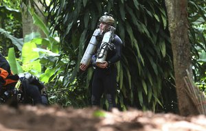 International rescuers team prepare walk in of a cave where a young soccer team and their coach are believed to be missing, Thursday, July 5, 2018, in Mae Sai, Chiang Rai province, in northern Thailand. With more rain coming, Thai rescuers are racing against time to pump out water from a flooded cave before they can extract 12 boys and their soccer coach with minimum risk, officials said Thursday. (AP Photo/Sakchai Lalit)