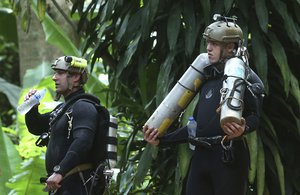 International rescuers team prepare to enter the cave where a young soccer team and their coach trapped by flood waters Thursday, July 5, 2018, in Mae Sai, Chiang Rai province, in northern Thailand.