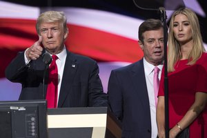 File - In this photo taken July 21, 2016, then-Trump Campaign manager Paul Manafort stands between the then-Republican presidential candidate Donald Trump and his daughter Ivanka Trump during a walk through at the Republican National Convention in Cleveland.